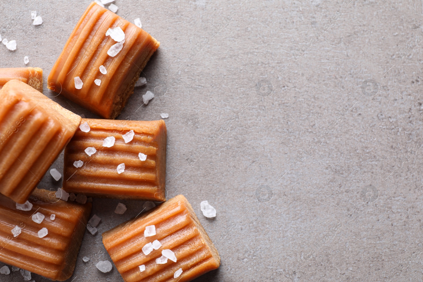 Photo of Salted caramel on light grey table, flat lay. Space for text