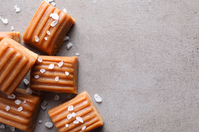 Salted caramel on light grey table, flat lay. Space for text