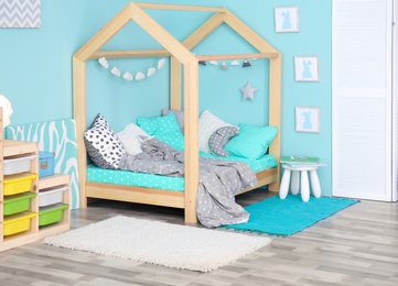 Photo of Comfortable bed in modern children room