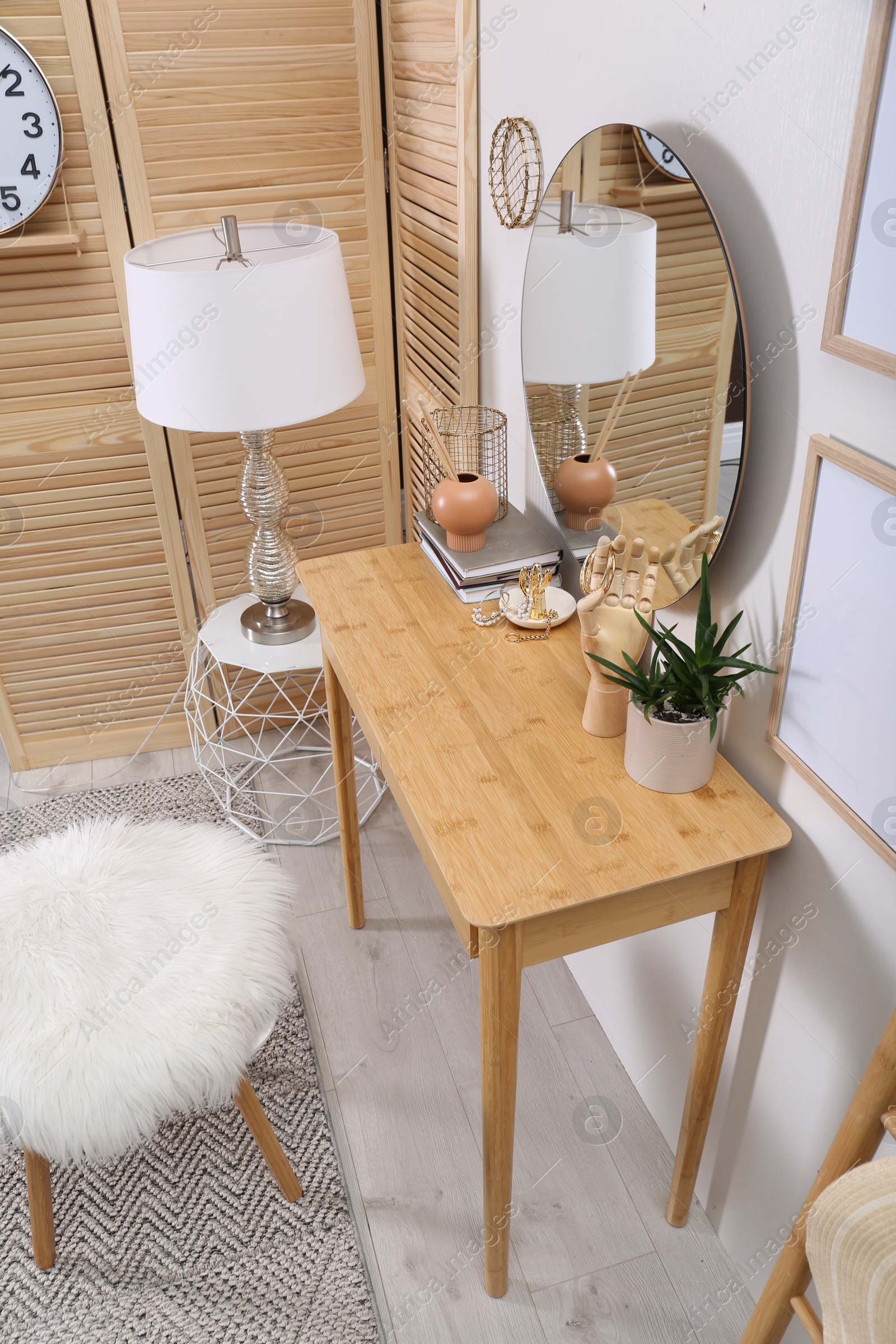 Photo of Modern wooden dressing table with mirror in room, above view