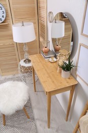 Modern wooden dressing table with mirror in room, above view