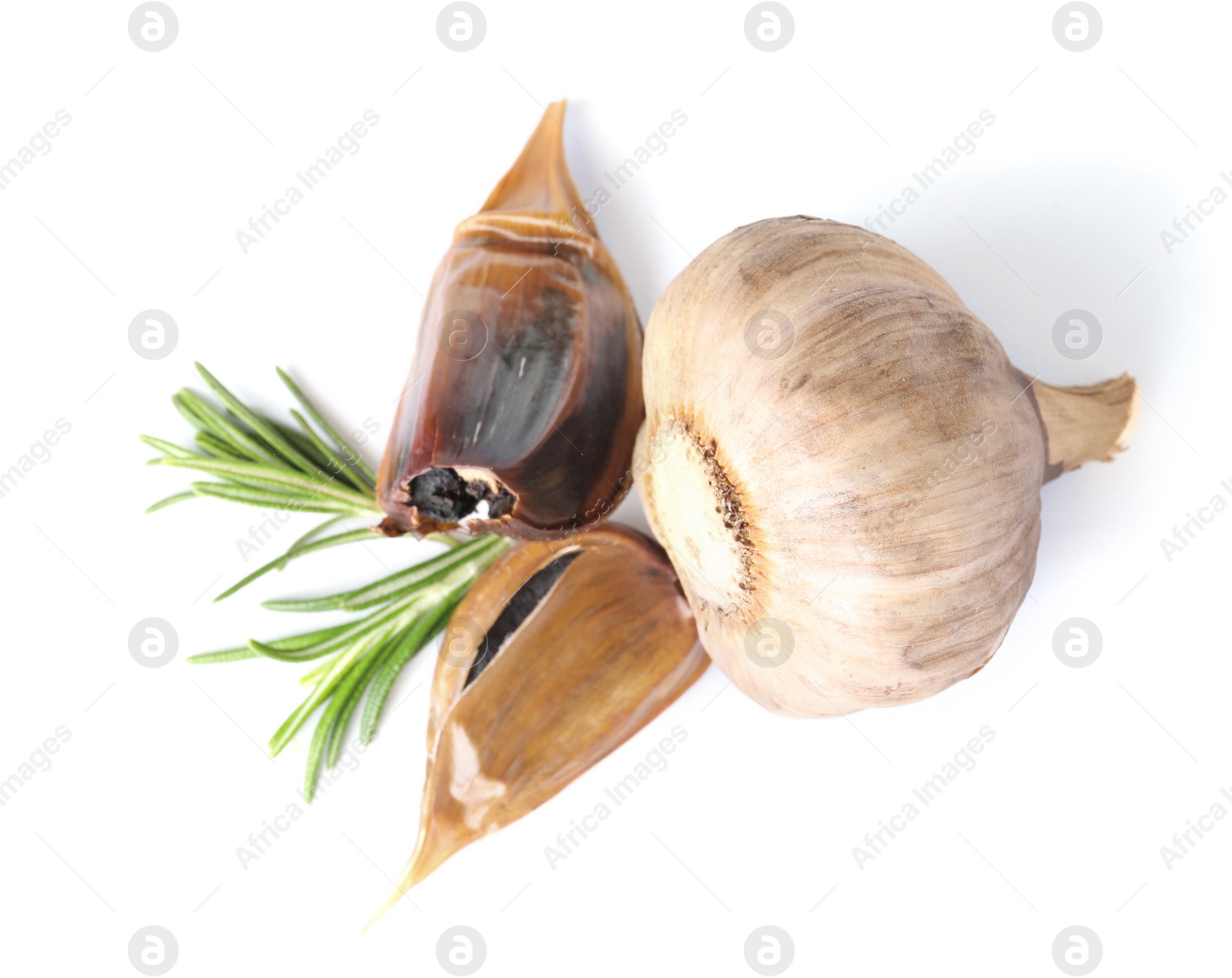 Photo of Aged black garlic with rosemary on white background, view from above