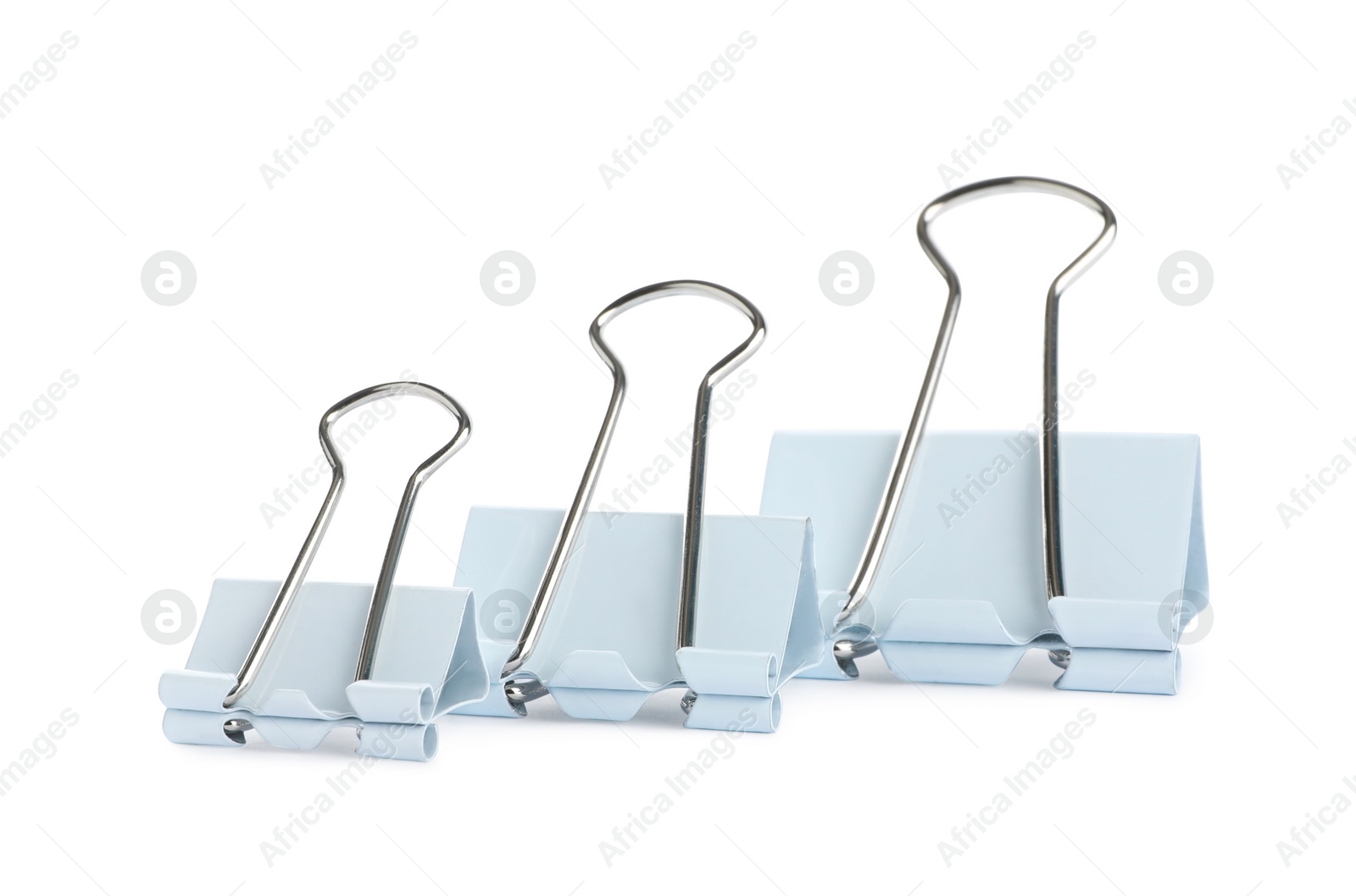 Photo of Different binder clips on white background. Stationery item