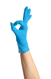 Photo of Woman in blue latex gloves showing OK gesture on white background, closeup of hand