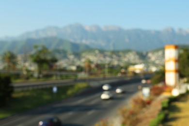 Photo of Blurred view of city and highway in mountains