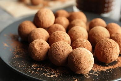 Photo of Plate with tasty chocolate truffles, closeup view