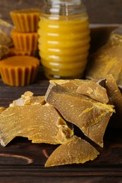 Photo of Natural beeswax blocks on wooden table, closeup