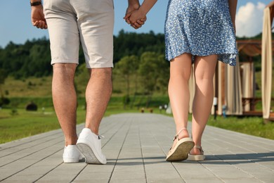 Romantic date. Couple walking outdoors, closeup view