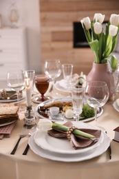 Photo of Festive Passover table setting at home. Pesach celebration