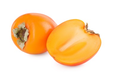 Photo of Whole and cut persimmon fruits isolated on white