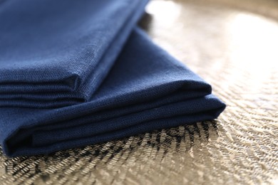 Photo of Blue kitchen napkins on textured background, closeup