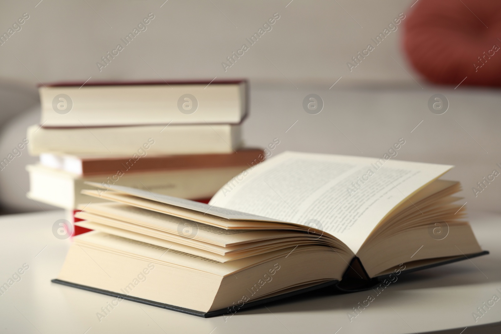 Photo of Open book on white table in room