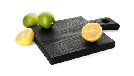 Photo of Wooden cutting board with cut lemon and limes isolated on white