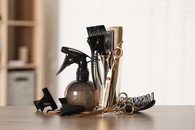 Photo of Set of hairdresser tools on table in salon