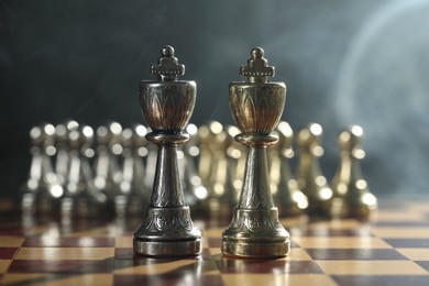 Photo of Kings in front of pawns on chessboard, selective focus