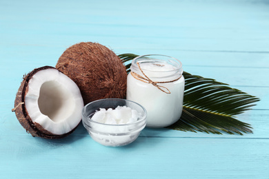 Composition with organic coconut oil on light blue wooden table. Healthy cooking