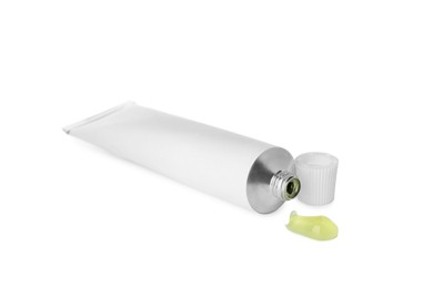 Photo of Open tube with ointment on white background