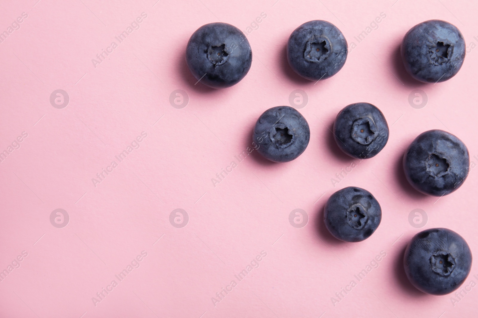 Photo of Flat lay composition with tasty blueberry and space for text on color background