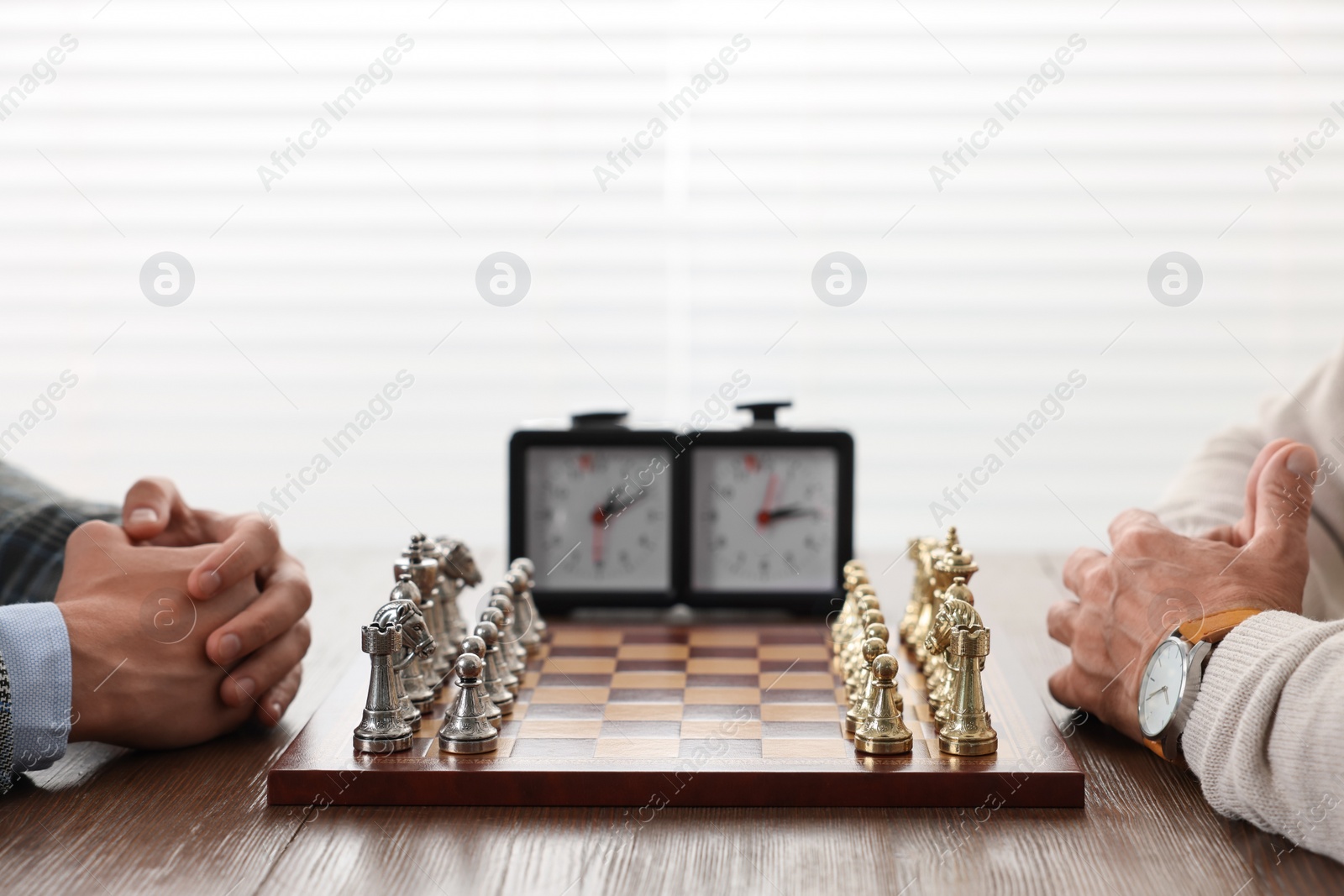 Photo of Men playing chess during tournament at table indoors, closeup