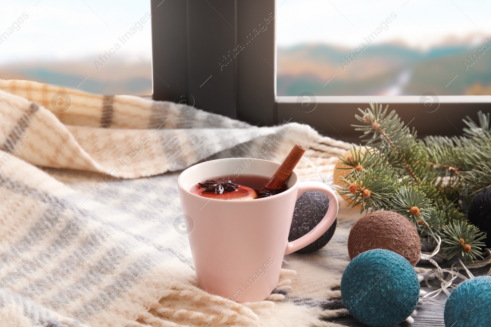 Photo of Composition with cup of hot winter drink and plaid near window. Cozy season