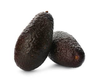 Photo of Whole fresh ripe avocadoes on white background