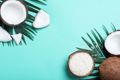 Photo of Flat lay composition with fresh coconut flakes on turquoise background. Space for text