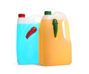 Photo of Plastic canisters with different liquids for car on white background