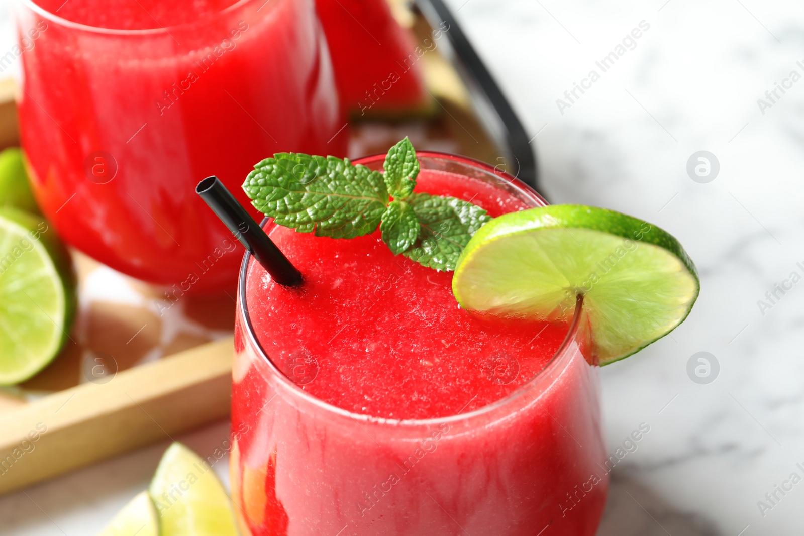 Photo of Summer watermelon drink with mint and lime on table, closeup