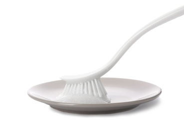 Photo of Cleaning dish with brush on white background