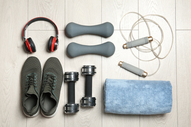 Photo of Set of fitness equipment and accessories on wooden background, flat lay