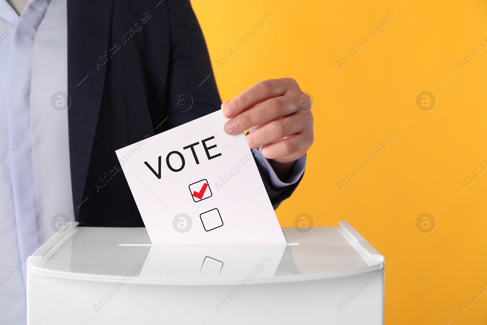 Image of Woman putting paper with word Vote and tick into ballot box on yellow background