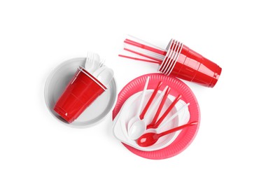 Photo of Set of bright disposable tableware on white background, top view