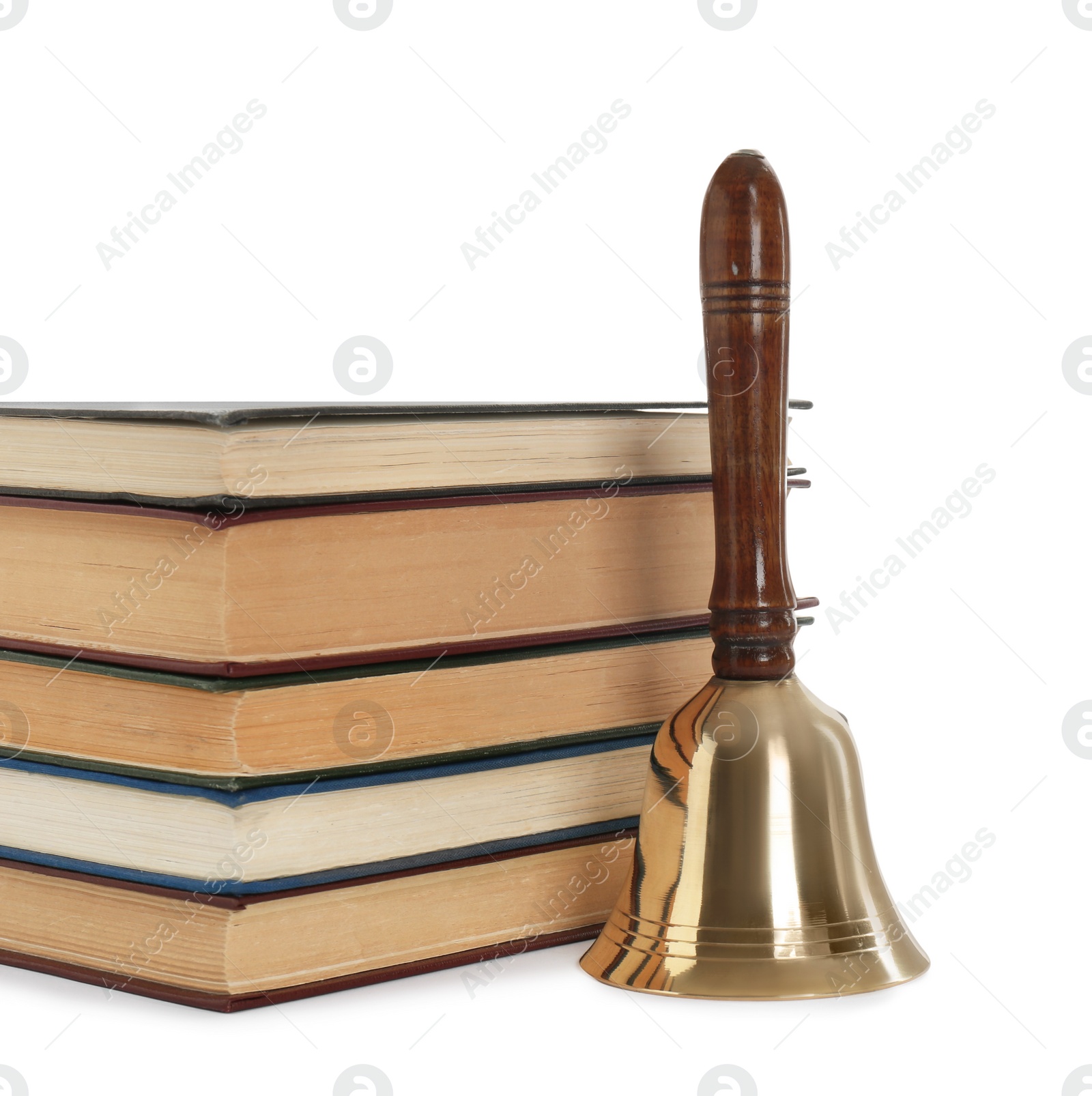 Photo of School bell with wooden handle and stack of books on white background