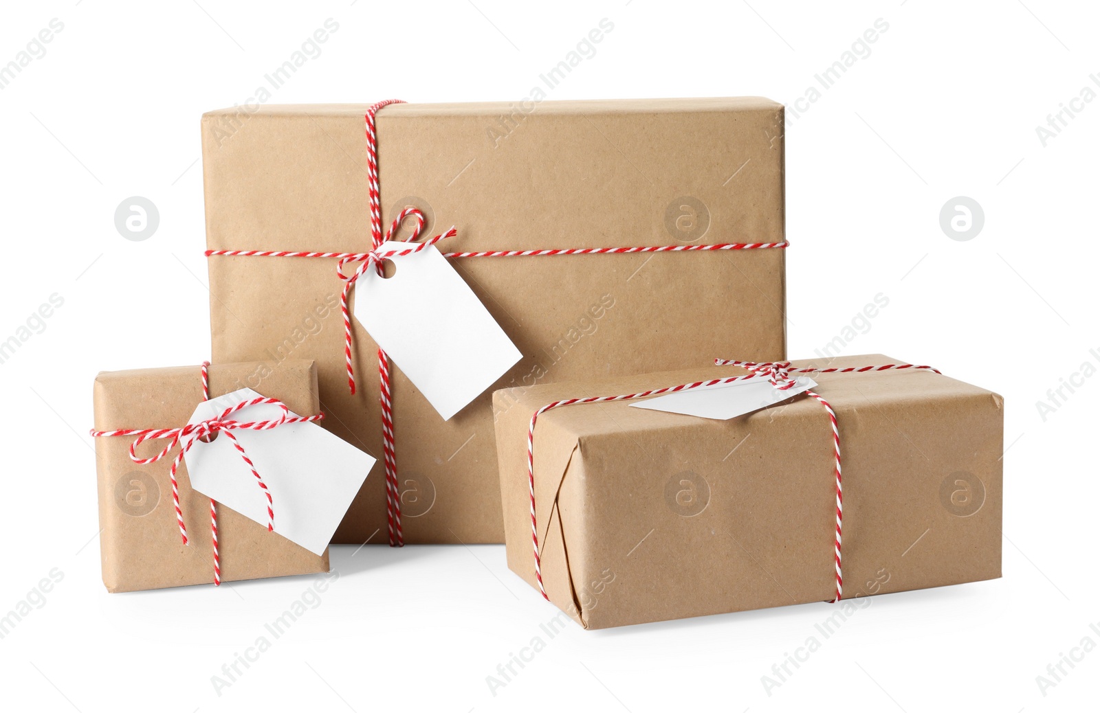 Photo of Gift boxes wrapped in kraft paper with tags on white background