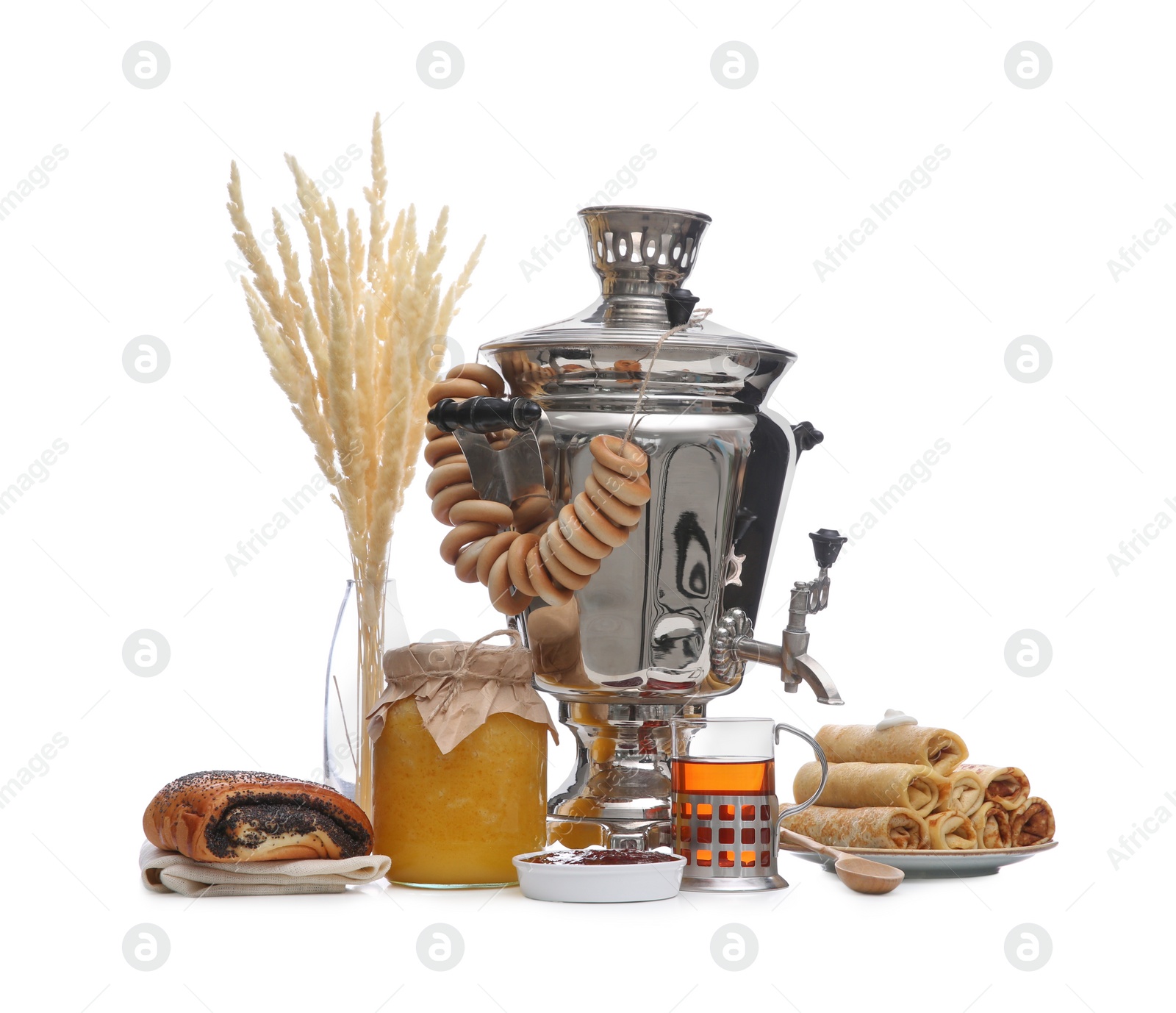 Photo of Traditional Russian samovar and treats on white background