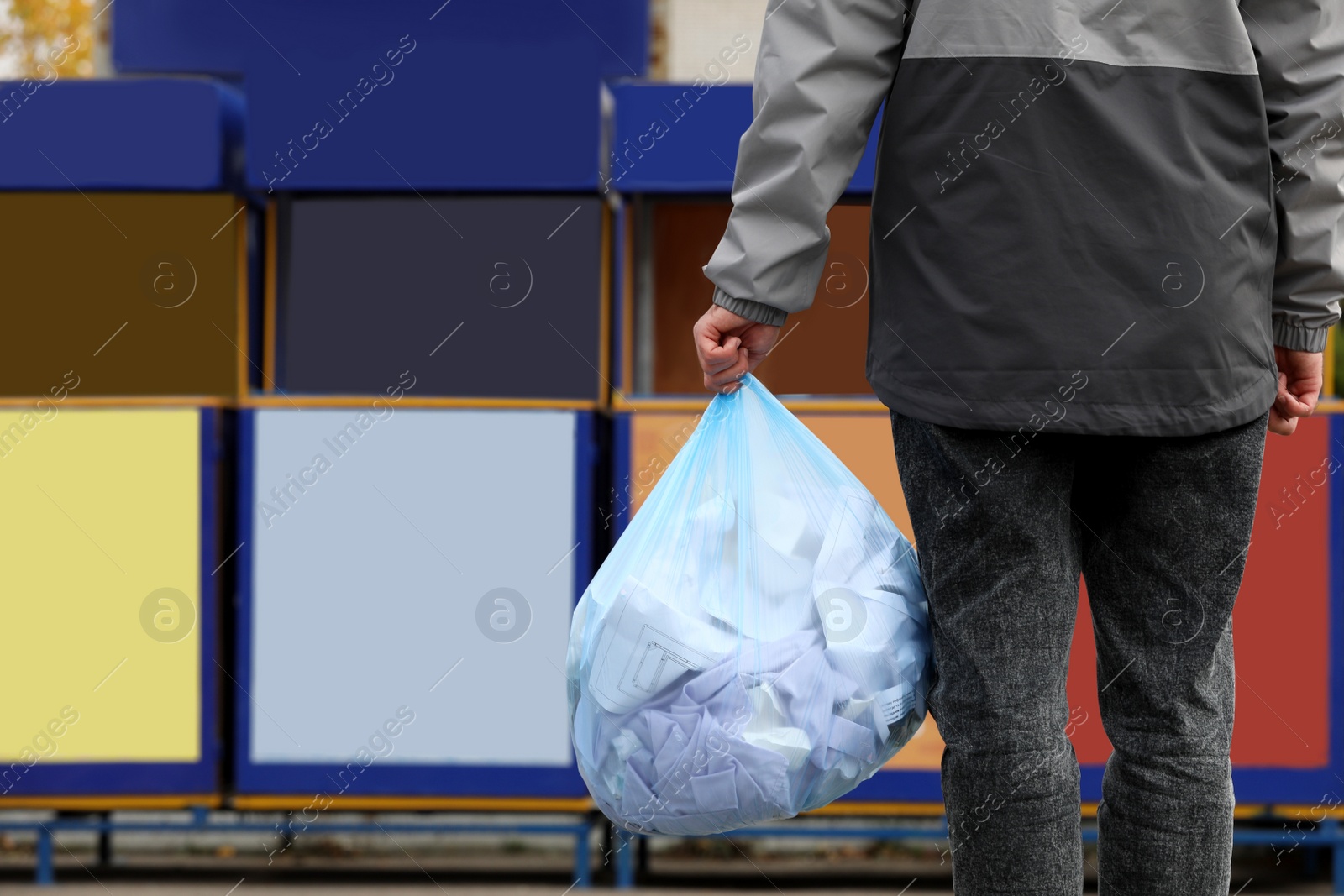 Photo of Man with garbage bag at recycling point outdoors, closeup