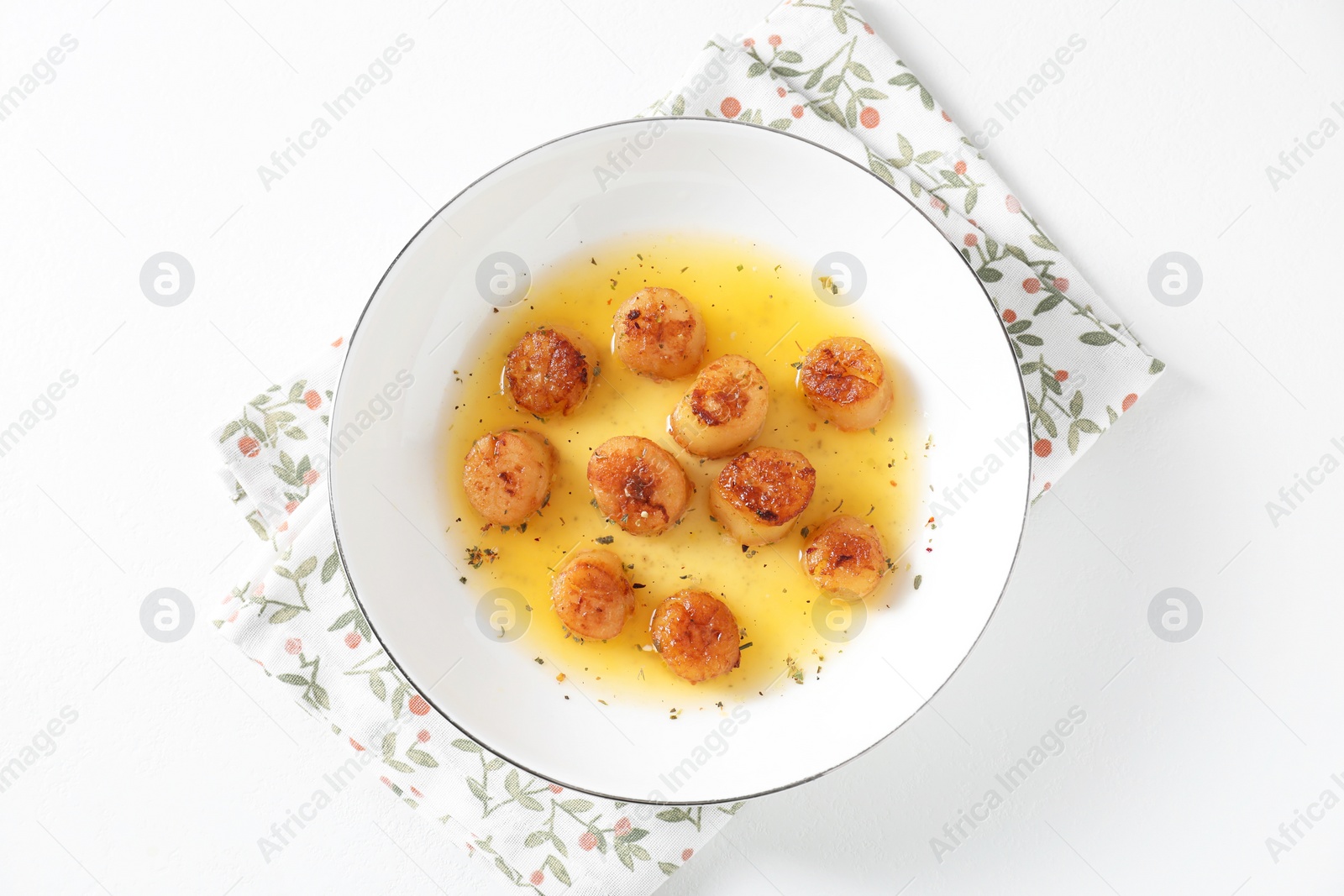 Photo of Delicious fried scallops with sauce on white table, top view