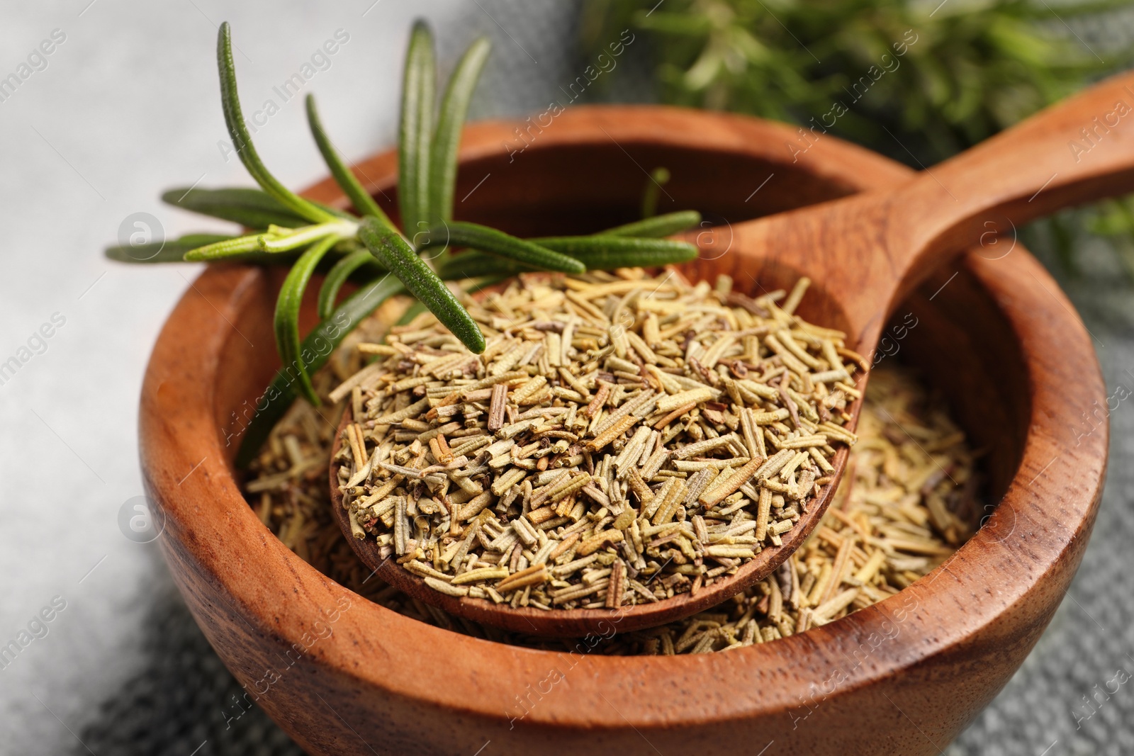 Photo of Fresh and dry rosemary on table, closeup