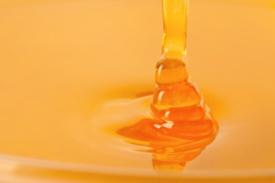 Photo of Pouring fresh sweet honey, closeup