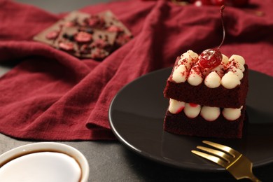Piece of red velvet cake and fork on table, closeup with space for text