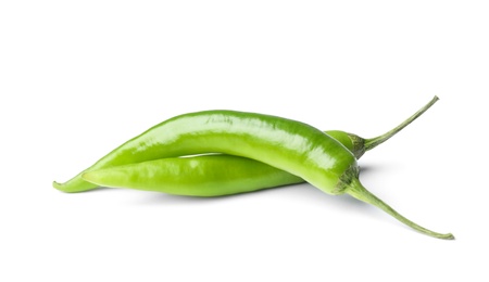 Photo of Ripe green hot chili peppers on white background