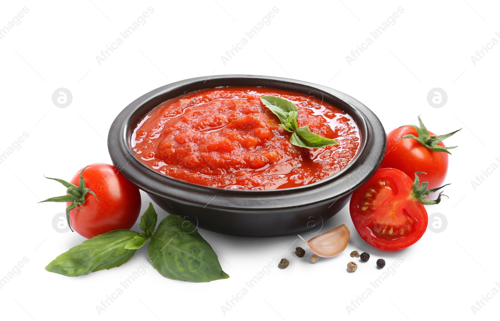 Photo of Homemade tomato sauce in bowl and fresh ingredients isolated on white