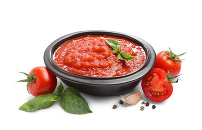 Photo of Homemade tomato sauce in bowl and fresh ingredients isolated on white