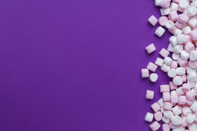 Photo of Delicious marshmallows on purple background, flat lay. Space for text