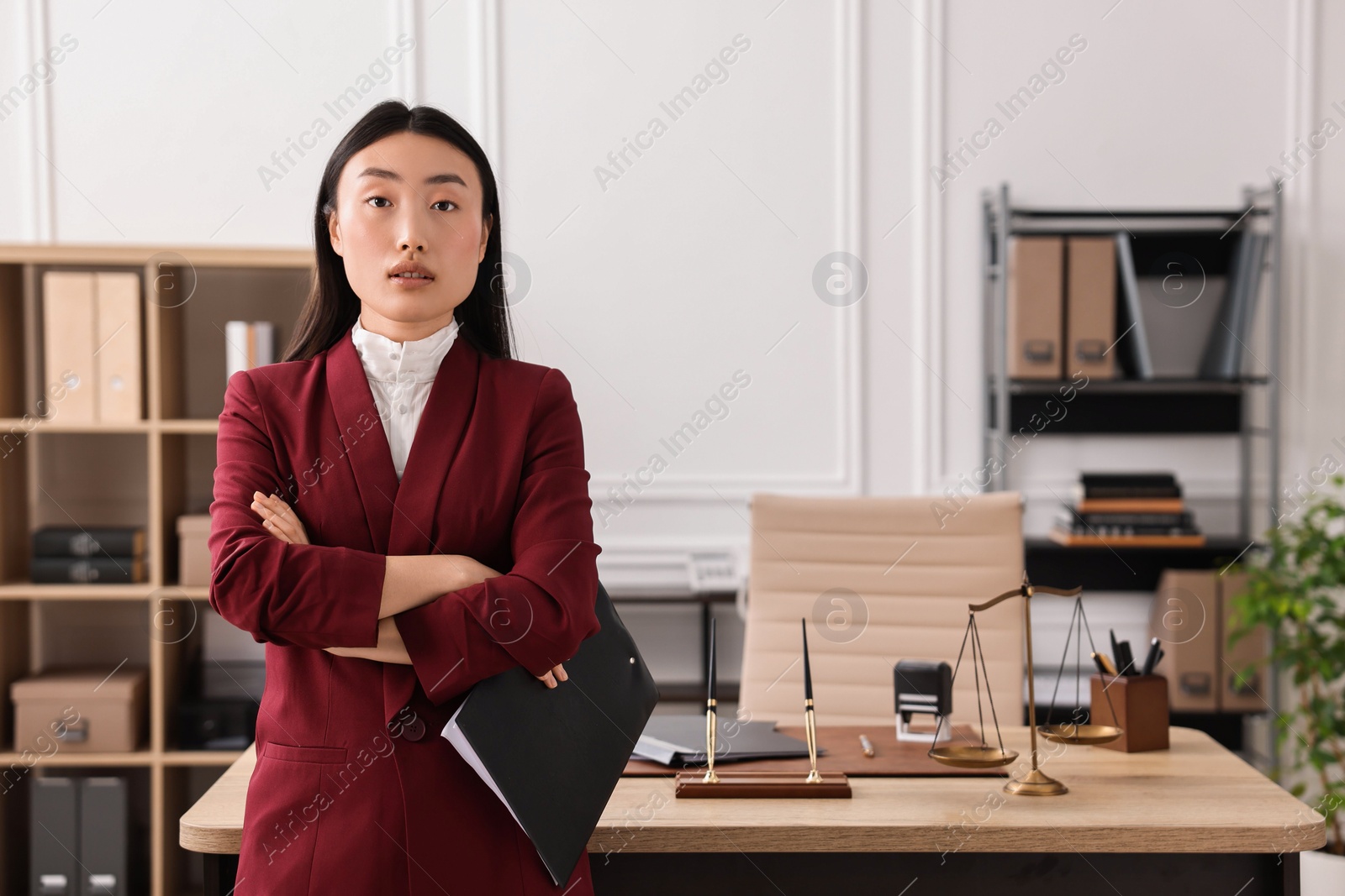 Photo of Portrait of notary with crossed arms in office. Space for text