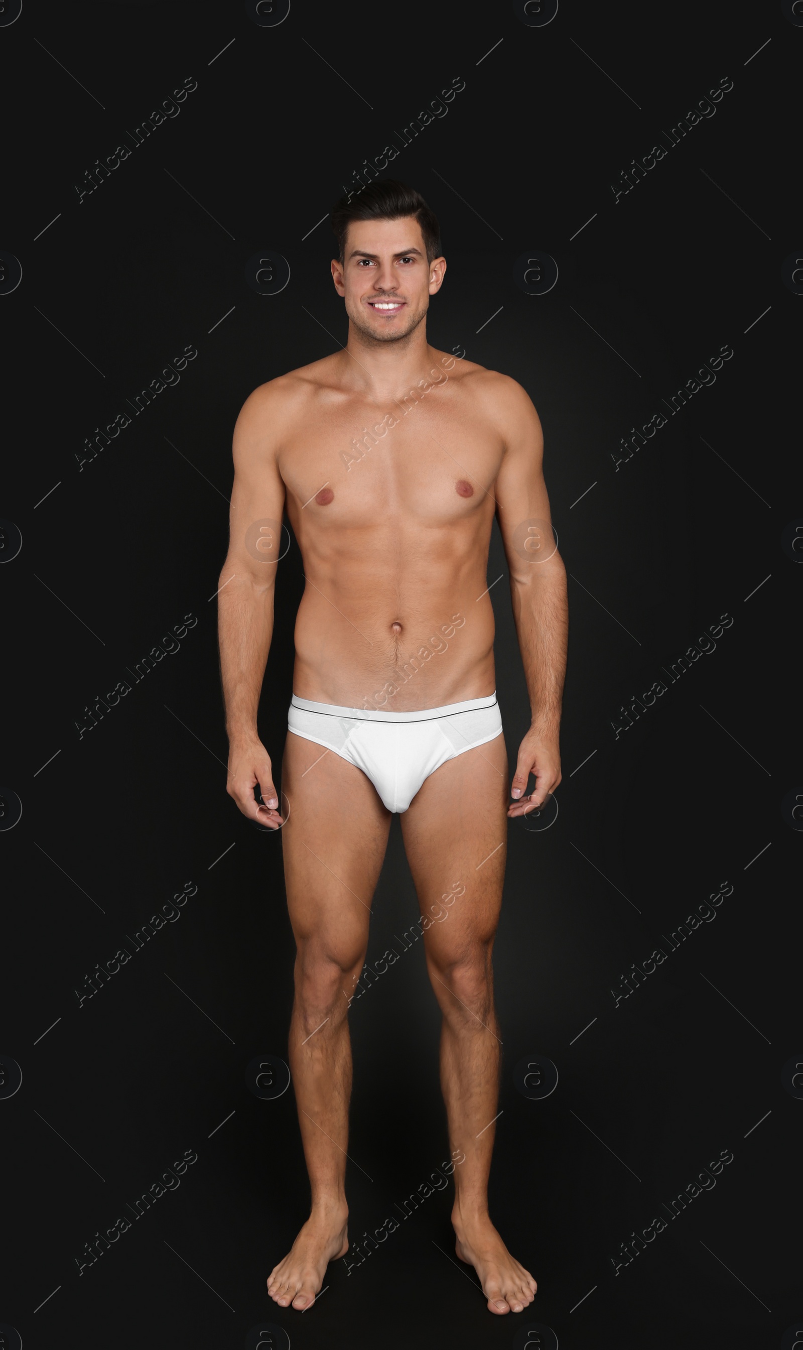 Photo of Handsome man in underwear on black background