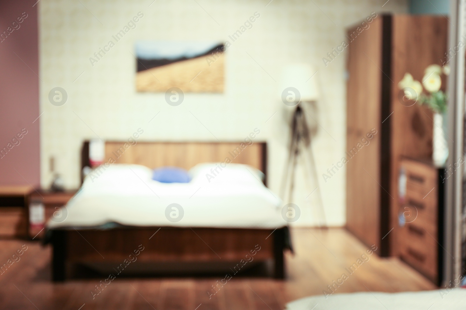 Photo of Blurred view of bedroom interior with stylish furniture