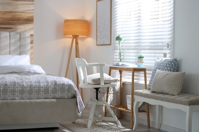 Photo of Comfortable workplace near window in modern bedroom