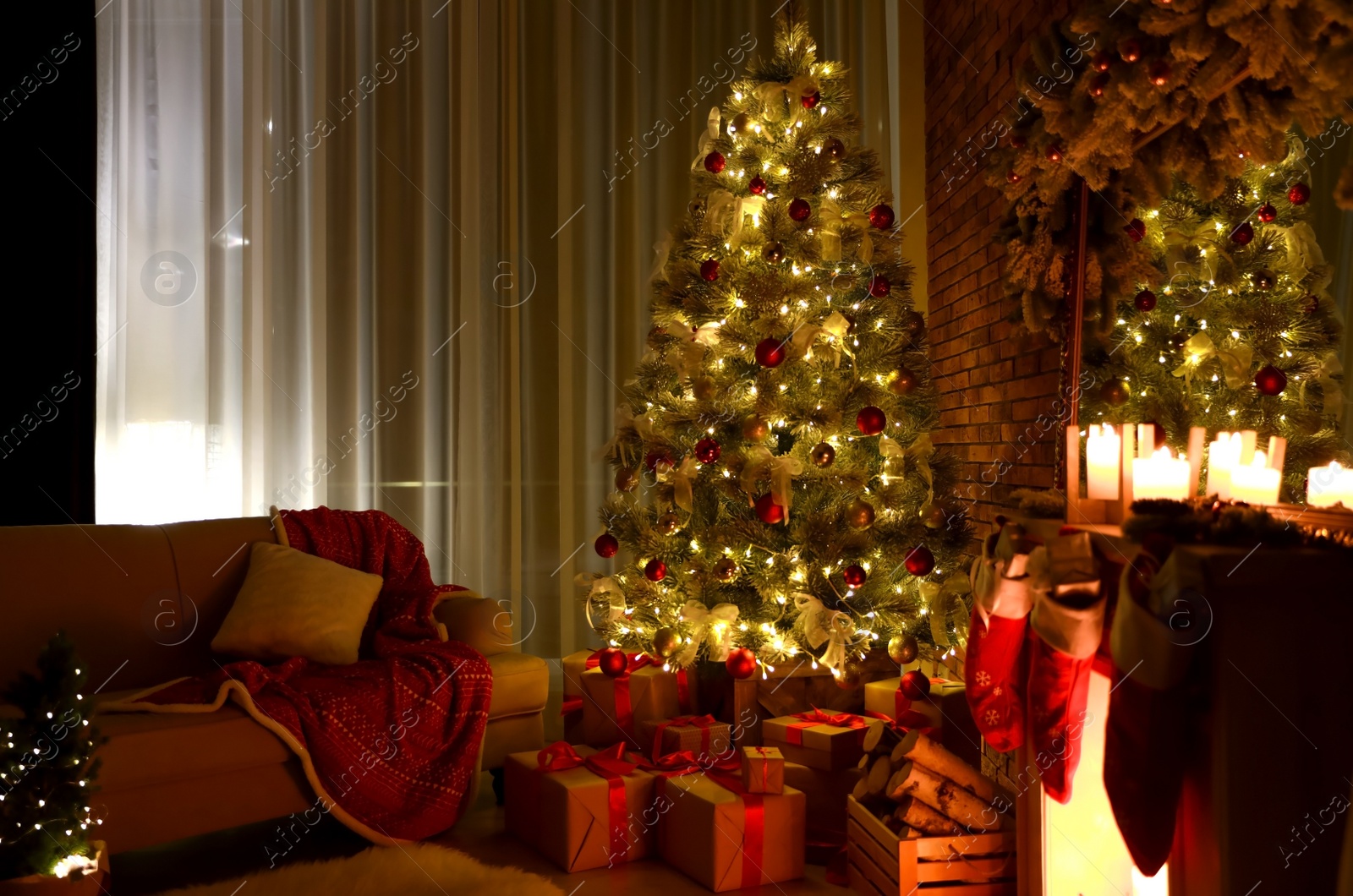 Photo of Stylish room interior with beautiful Christmas tree in evening