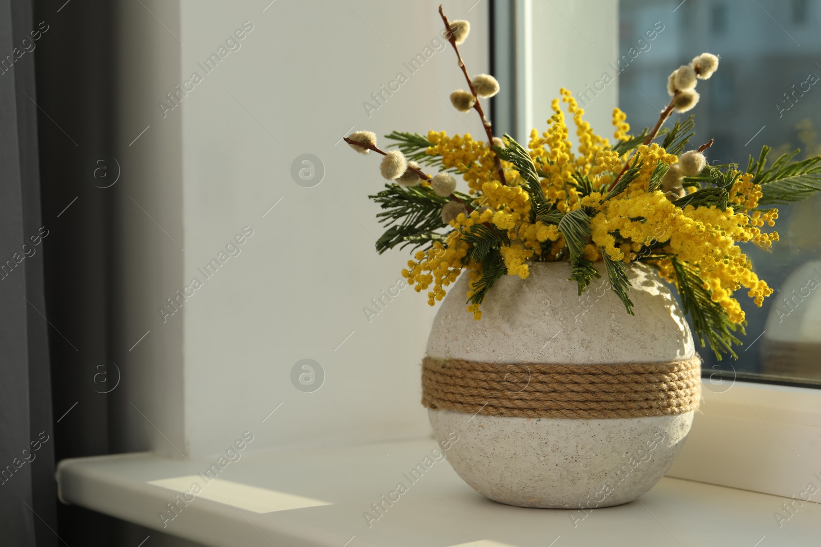 Photo of Beautiful mimosa flowers in vase on window sill indoors, space for text